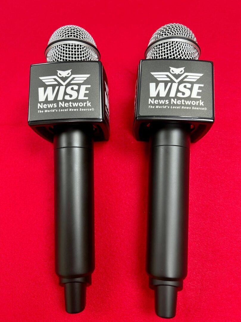 Two black handheld microphones with "WISE News Network" logos on a red background.