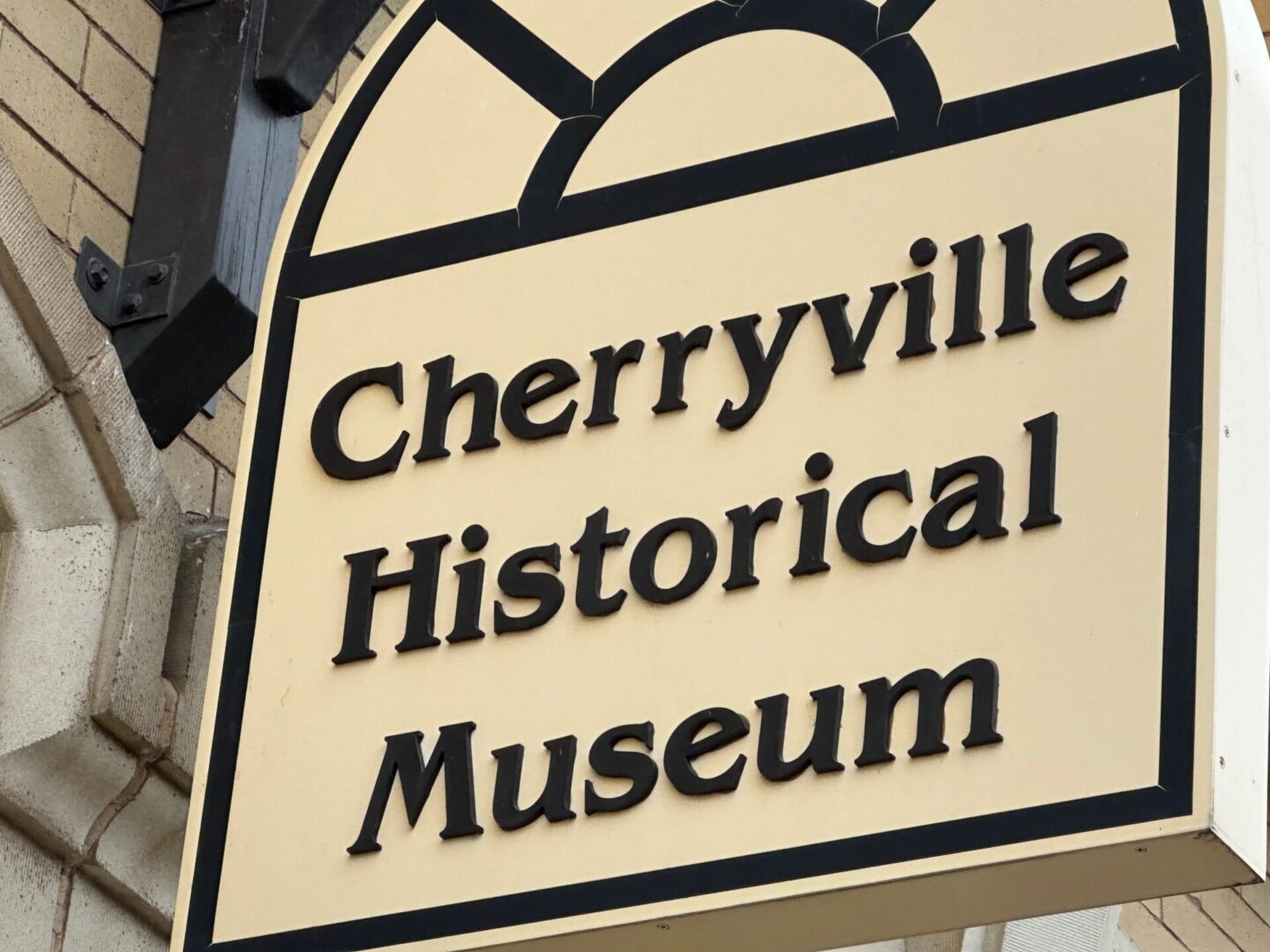 Sign reading "Cherryville Historical Museum" mounted on an exterior brick wall.