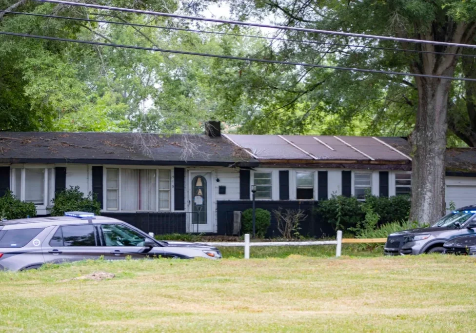 A house with a car parked in front of it.