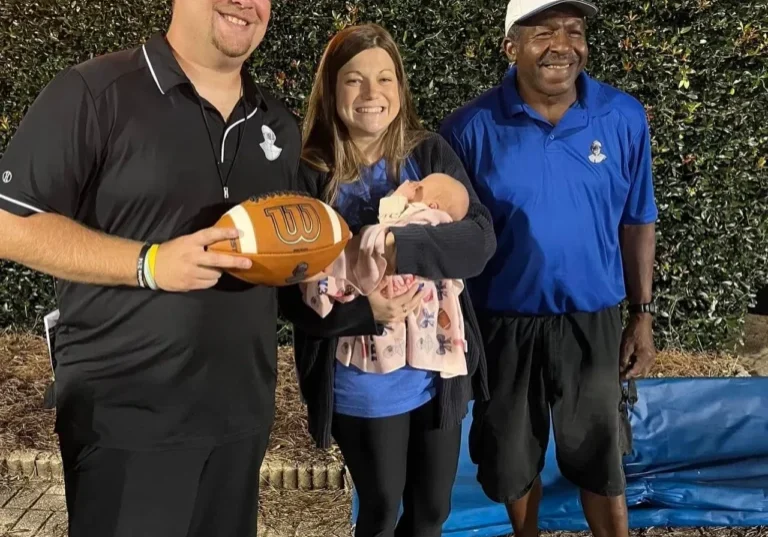 Ironmen Head Coach Patrick Bowman (L), his wife Sydney with newborn daughter (C), and Coach Lee Roy Montgomery