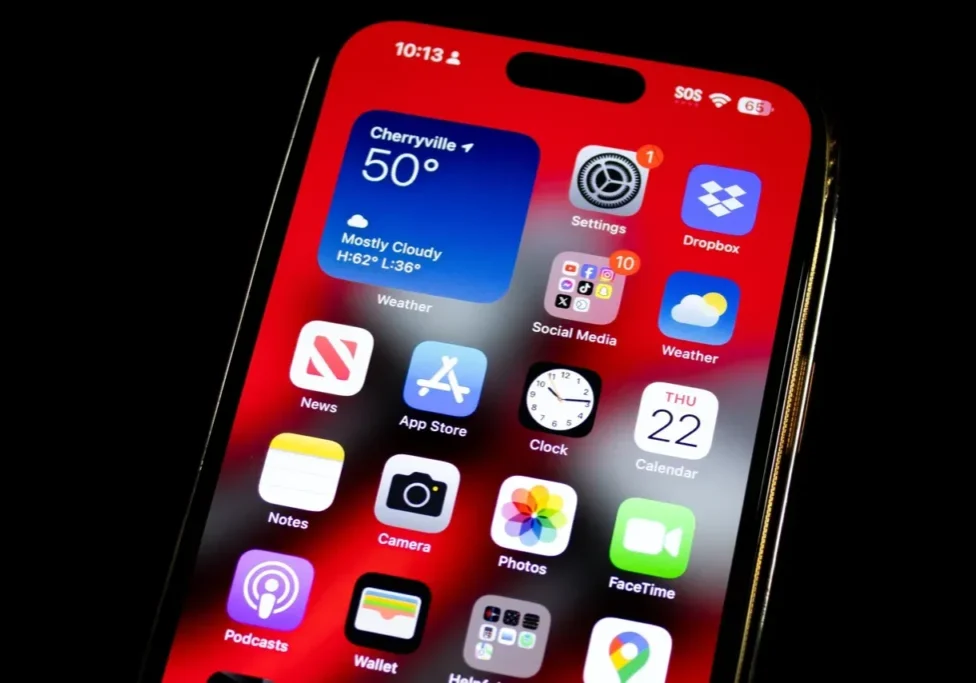 A close up of an iphone with the home screen showing.